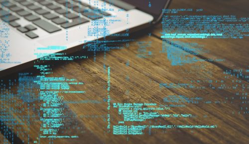 digital composite of laptop with hacking graphic